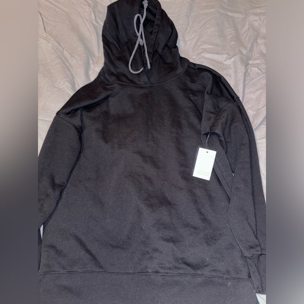 oversized size small plain black hoodie. never worn. tags still on.